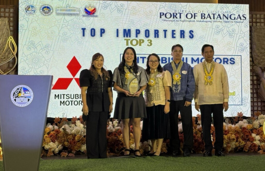 MMPC executives and BOC officials posing on stage with a plaque recognizing Mitsubishi Motors Philippines as a Top 3 Importer at the BOC Port of Batangas review