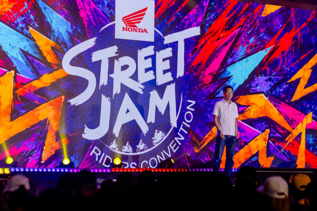 A Honda Philippines executive delivers a presentation on stage in front of a giant "Street Jam Riders Convention" digital screen at the Honda Riders Convention Visayas.