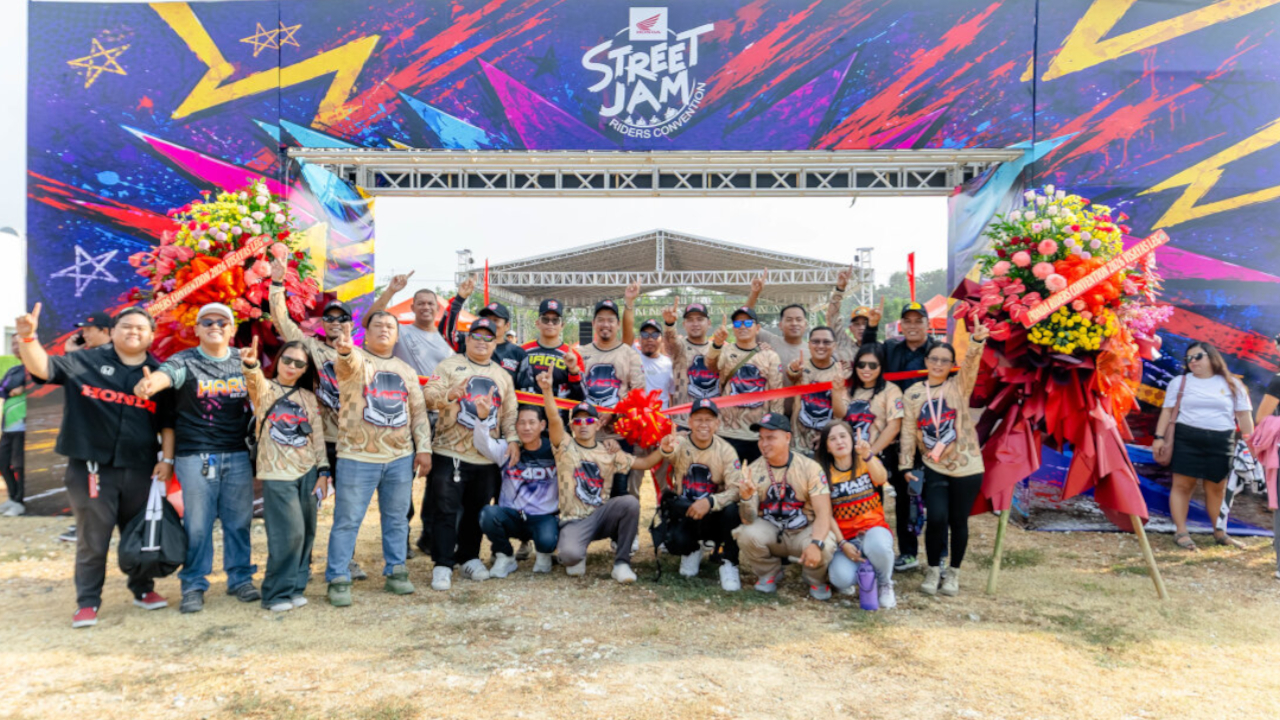 Group photo of motorcycle club members holding a red ribbon during the official opening ceremonies of the Honda Riders Convention Visayas.