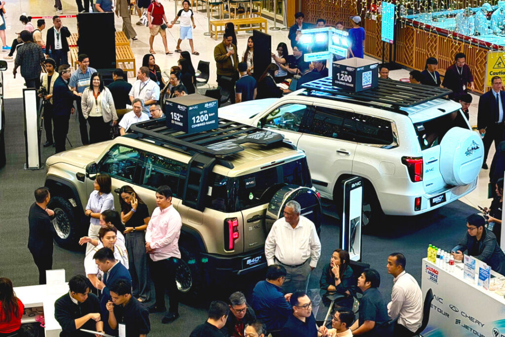 Crowded event floor showcasing the BAIC B40e and B60e SUVs with the extensive new BAIC Philippines warranty coverage.