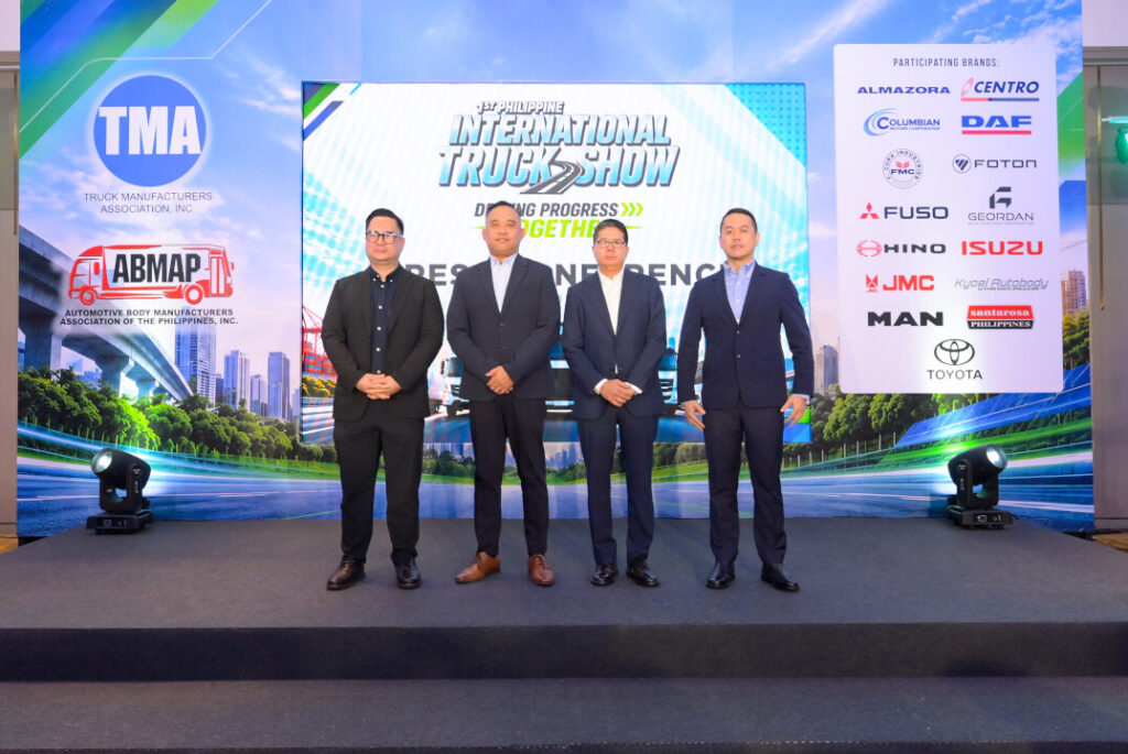 Key organizational leaders standing on stage in front of the Philippine International Truck Show banner and participating brand logos