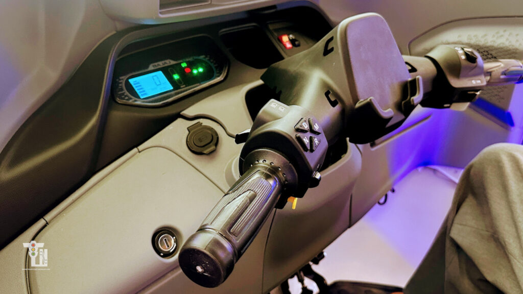 Dashboard controls of the Bajaj WeGo P5009 showing driving modes including Eco, Power, Climb, and Park Assist