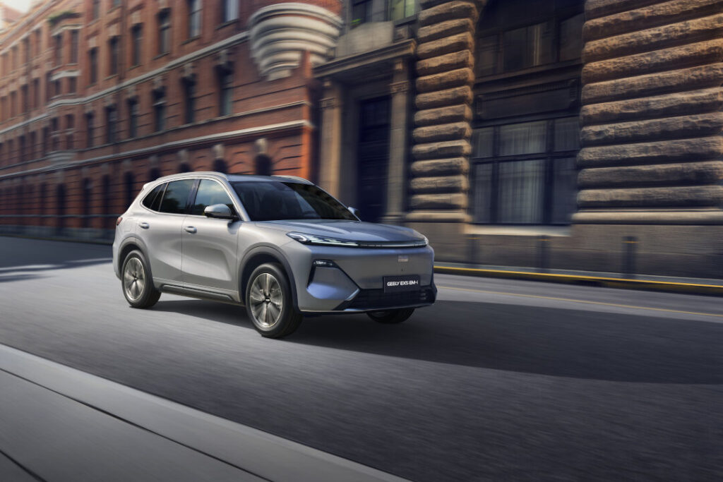 Silver Geely EX5 EM-i driving on a city street, featured in the Geely Philippines Mid-Autumn Deals.