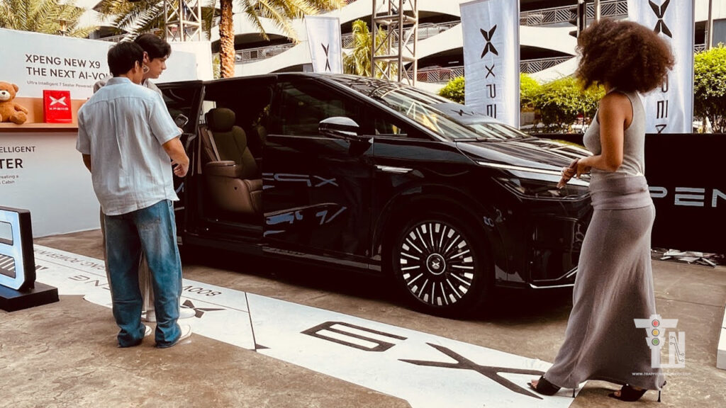 Executives looking Xpeng X9 displayed during the official Philippine launch