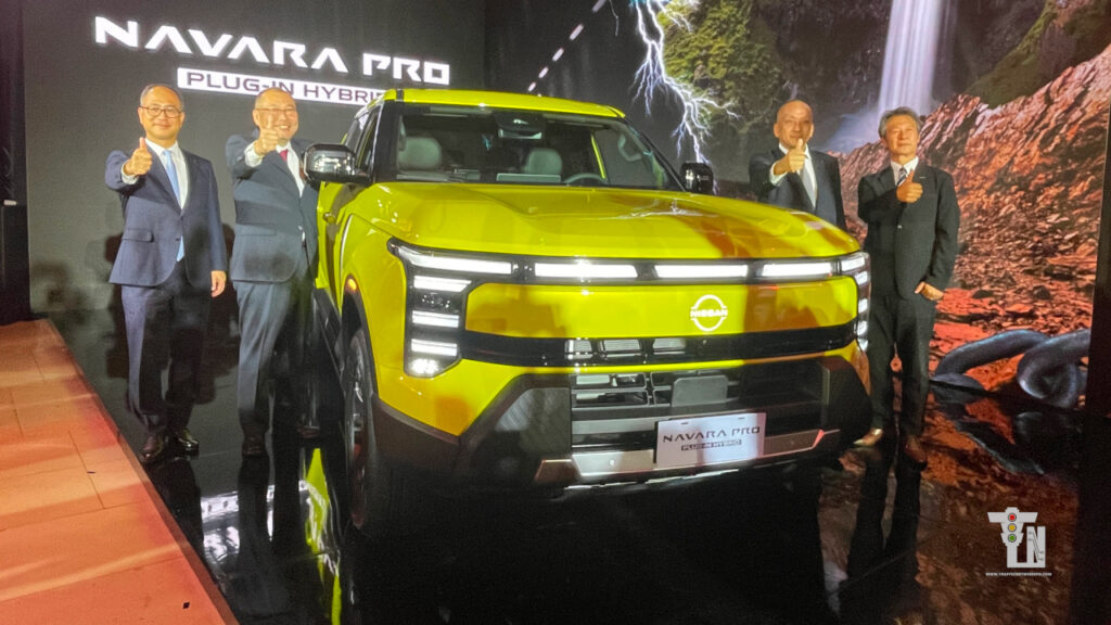 Nissan executives posing alongside the all-new Nissan Navara PHEV sedan during its official Philippines market reveal