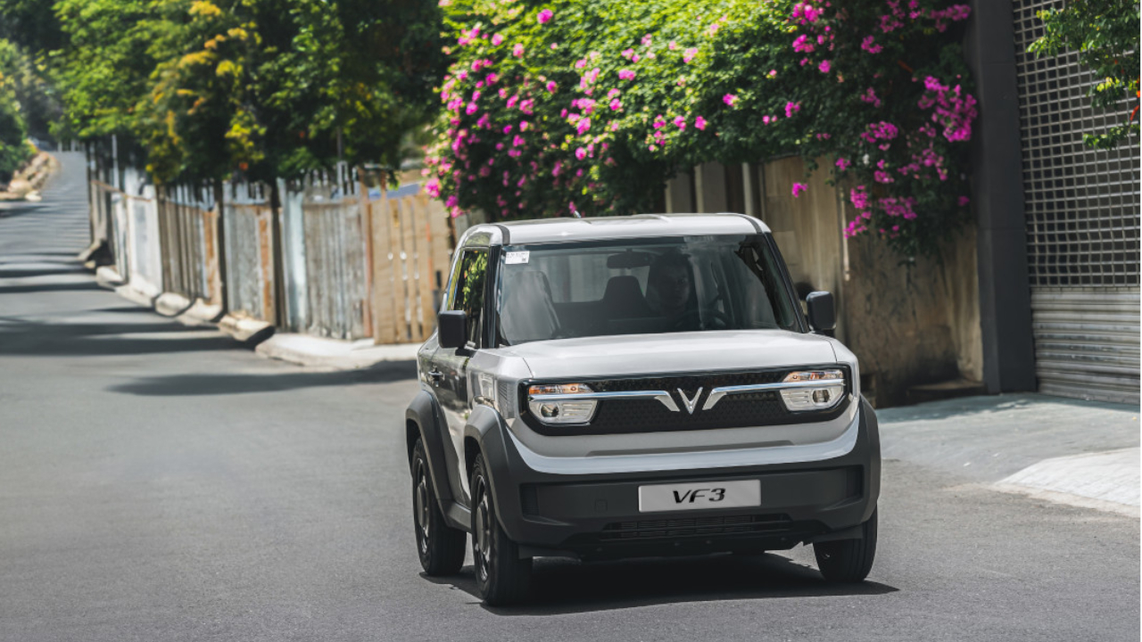 Landscape view of a white VinFast VF 3 electric car on a local street in the Philippines. This model benefits from VinFast's comprehensive 10-year vehicle and battery warranty.