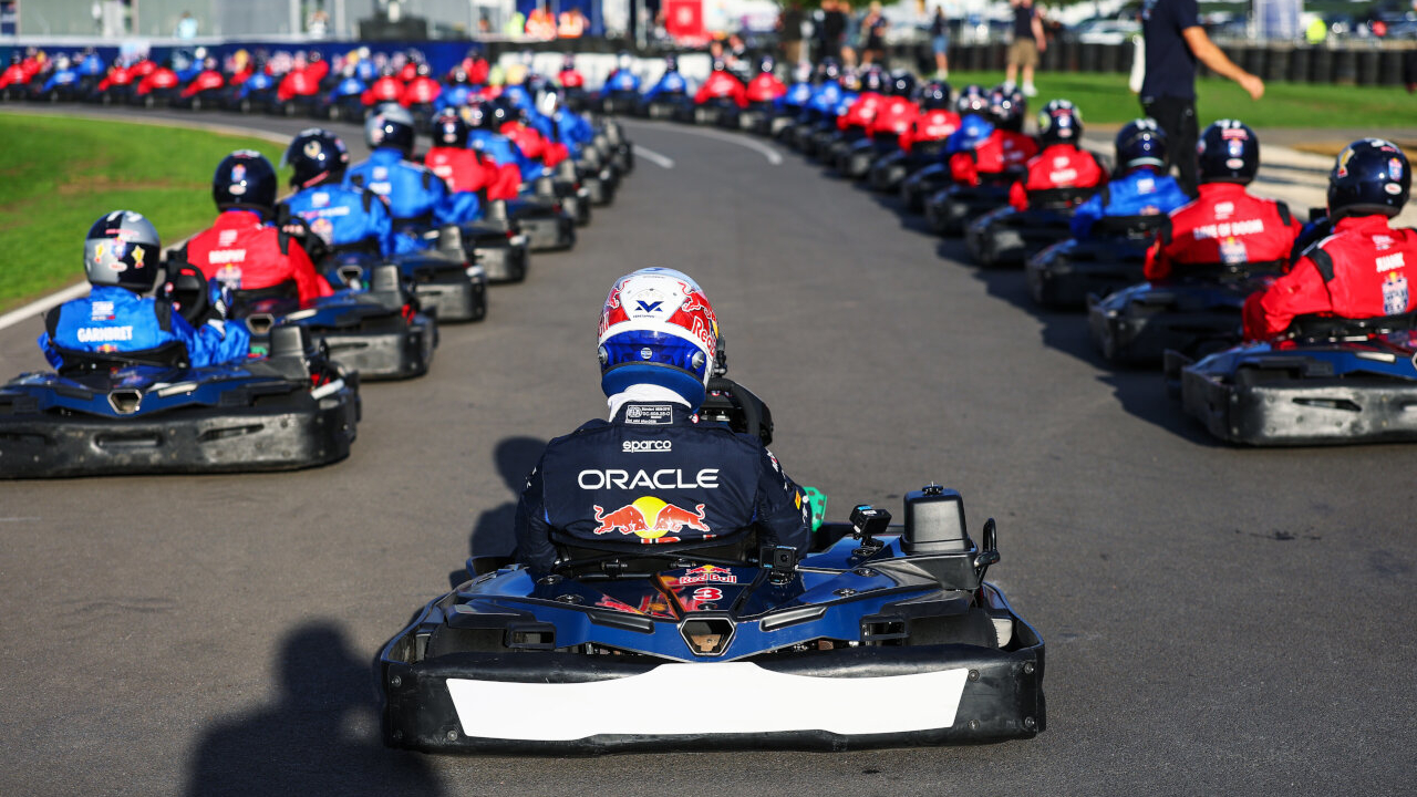 Close up of Rear view of Max Verstappen in his kart on the massive starting grid of the Max vs 100 race