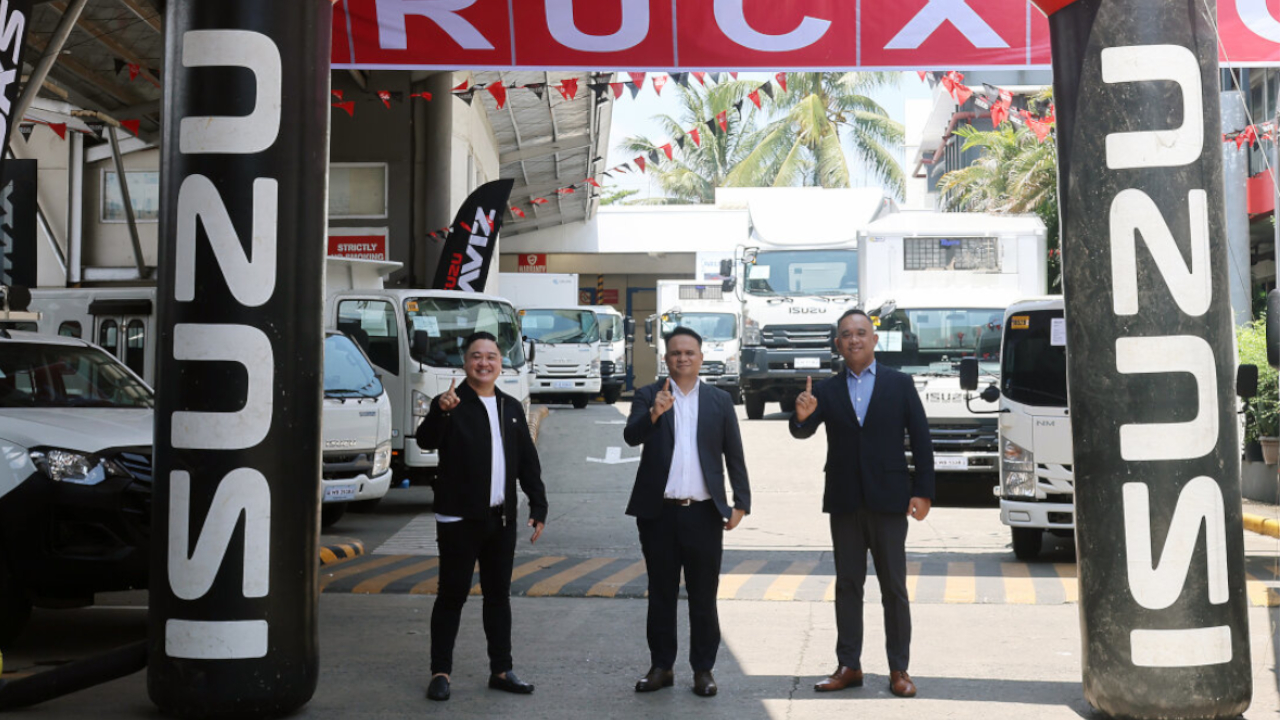 A medium shot of Isuzu management representatives welcoming attendees and industry stakeholders to the vehicle display area of the Isuzu Trucxpo 2026 Mindanao expo.